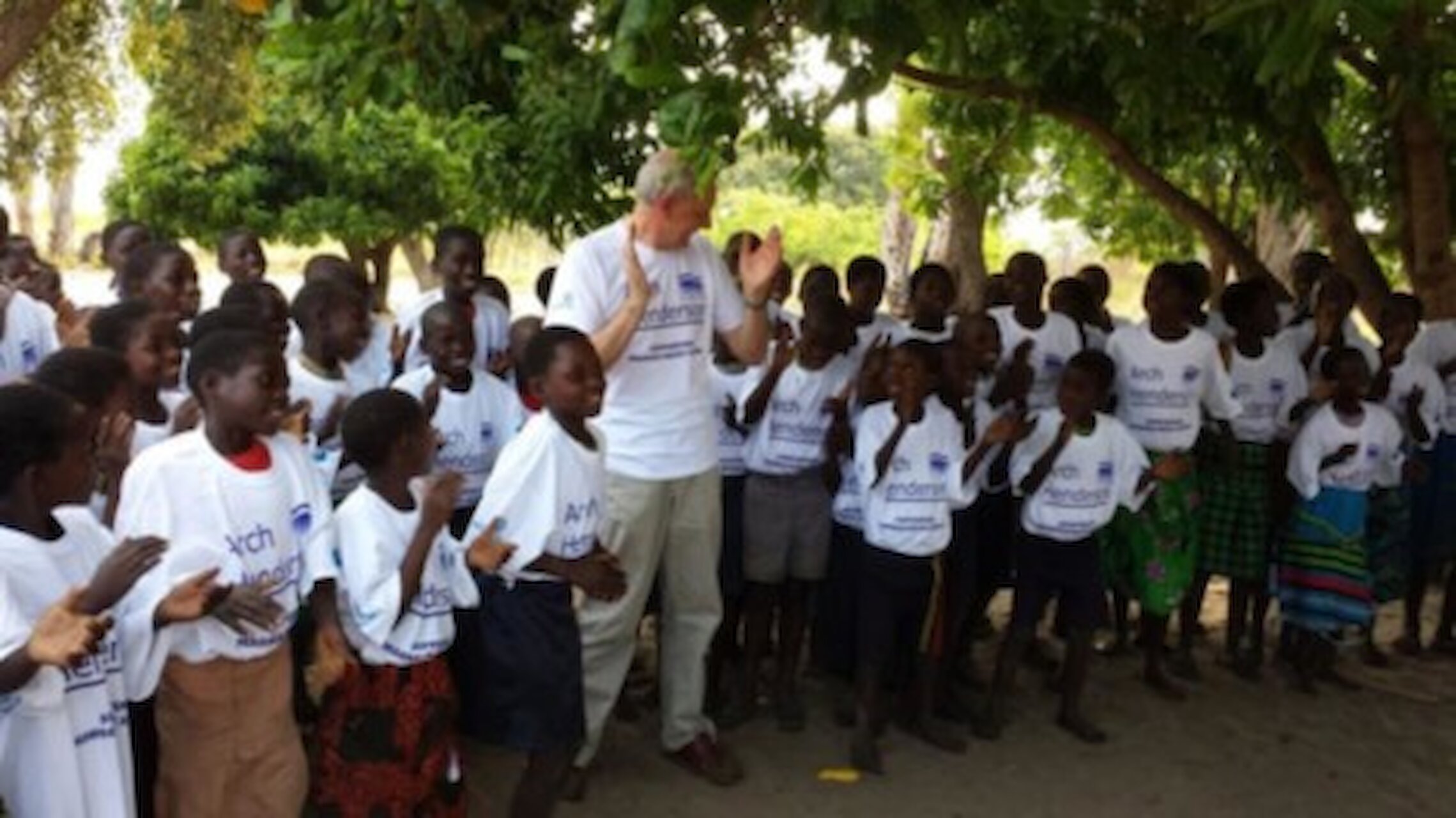 James Simpson, on a visit to a school in Zambia to see the newly installed fresh water well. He taught them to sing the Northern Lights of Aberdeen.