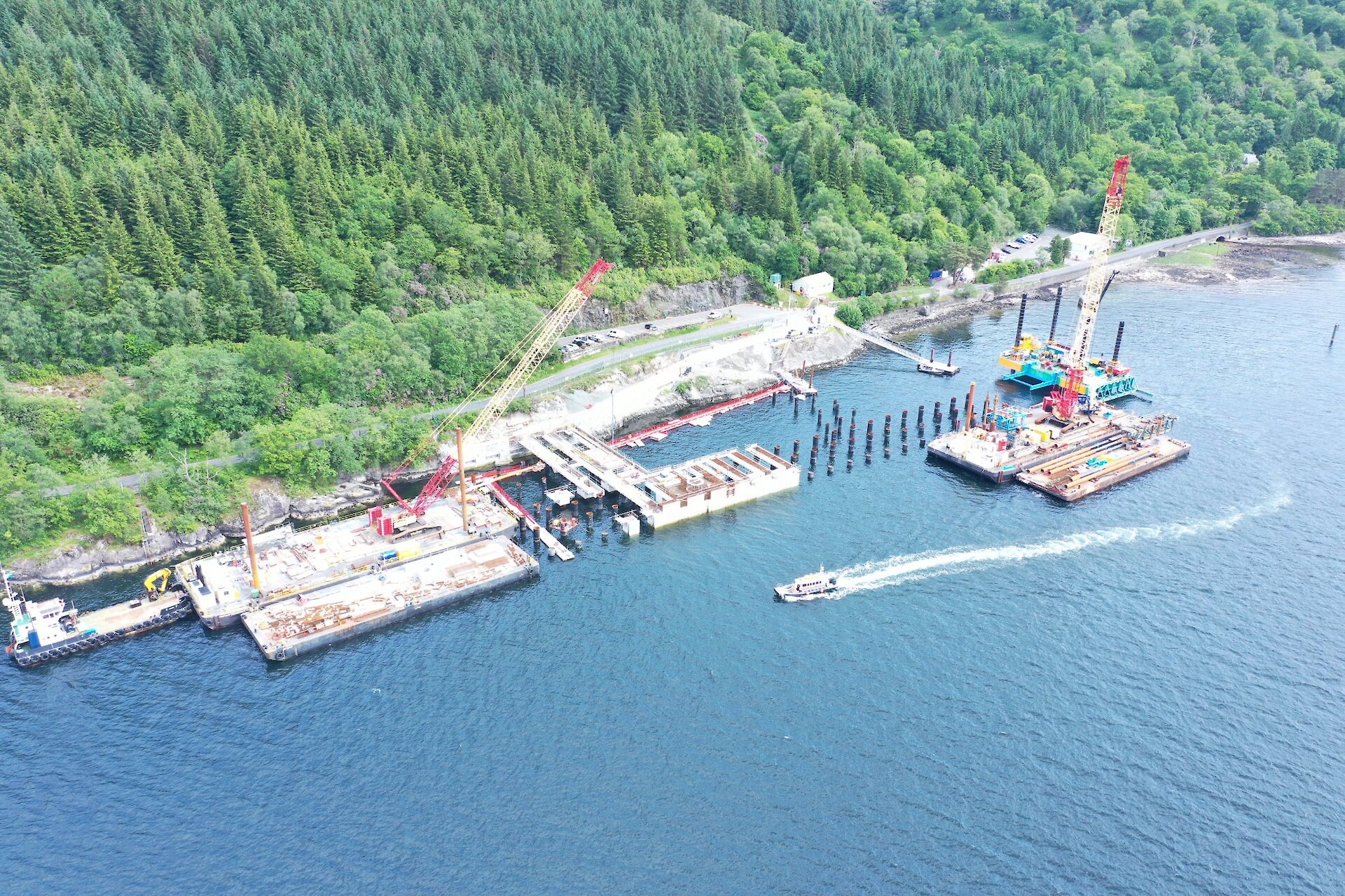 Drone shot showing piling works on dolphin 4 and deck construction progressing along the jetty head