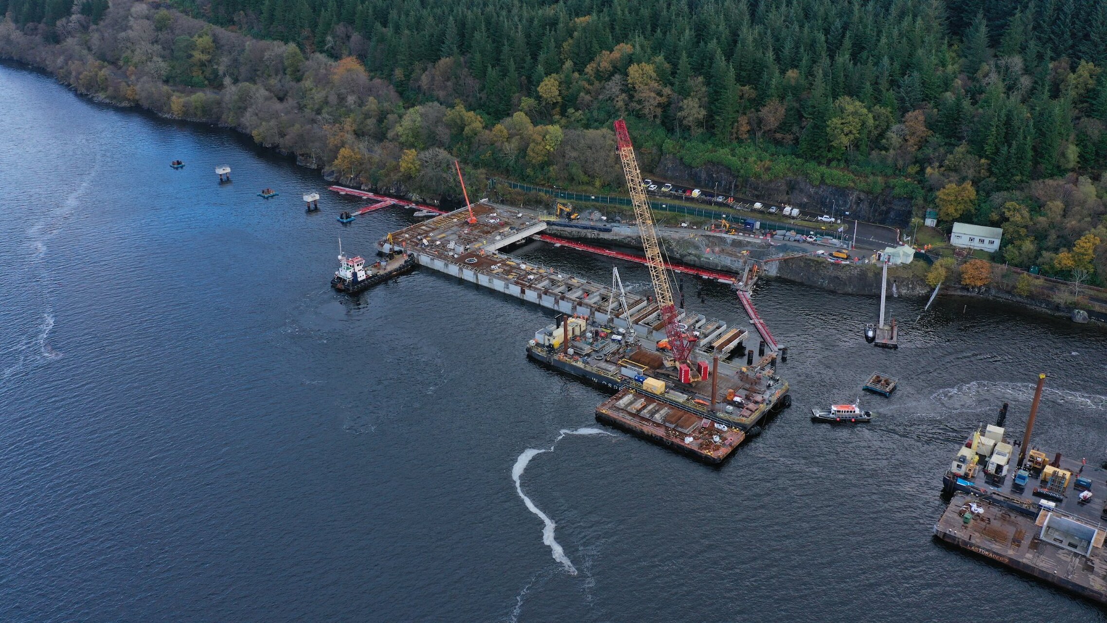 Drone shot showing deck construction progressing along the jetty head